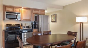 Enjoy family meals and gatherings in this kitchen and dining area with a dining table and four chairs.