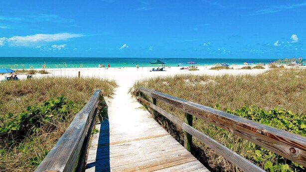 A wooden boardwalk leading to a beach with clear skies and calm waters. - Beautiful 3 bdrm Private home with HEATED pool 5 mi from Anna Maria Island!! (Bradenton)