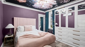 Une chambre à coucher avec un lit, une table de chevet et une armoire.