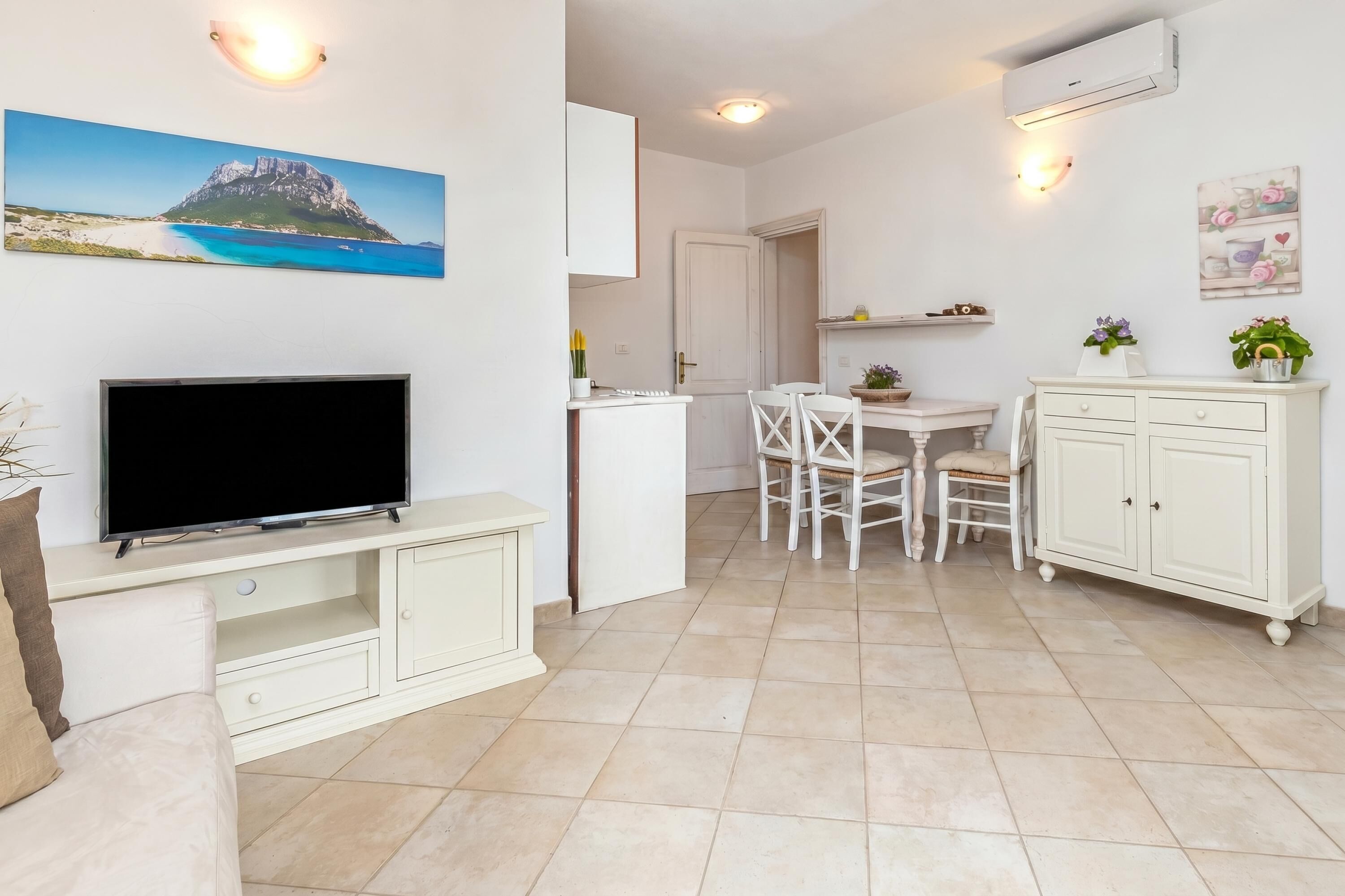 Family Apartment, Multiple Bedrooms (Domos Pintadas Apt. 4 Porto Rotondo) | Living area | 21-inch TV with cable channels