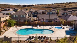 A residential area with a swimming pool surrounded by houses and a hilly landscape in the background. - Large 5 Bed 5 Bath Home w/Private Hot Tub (Washington)
