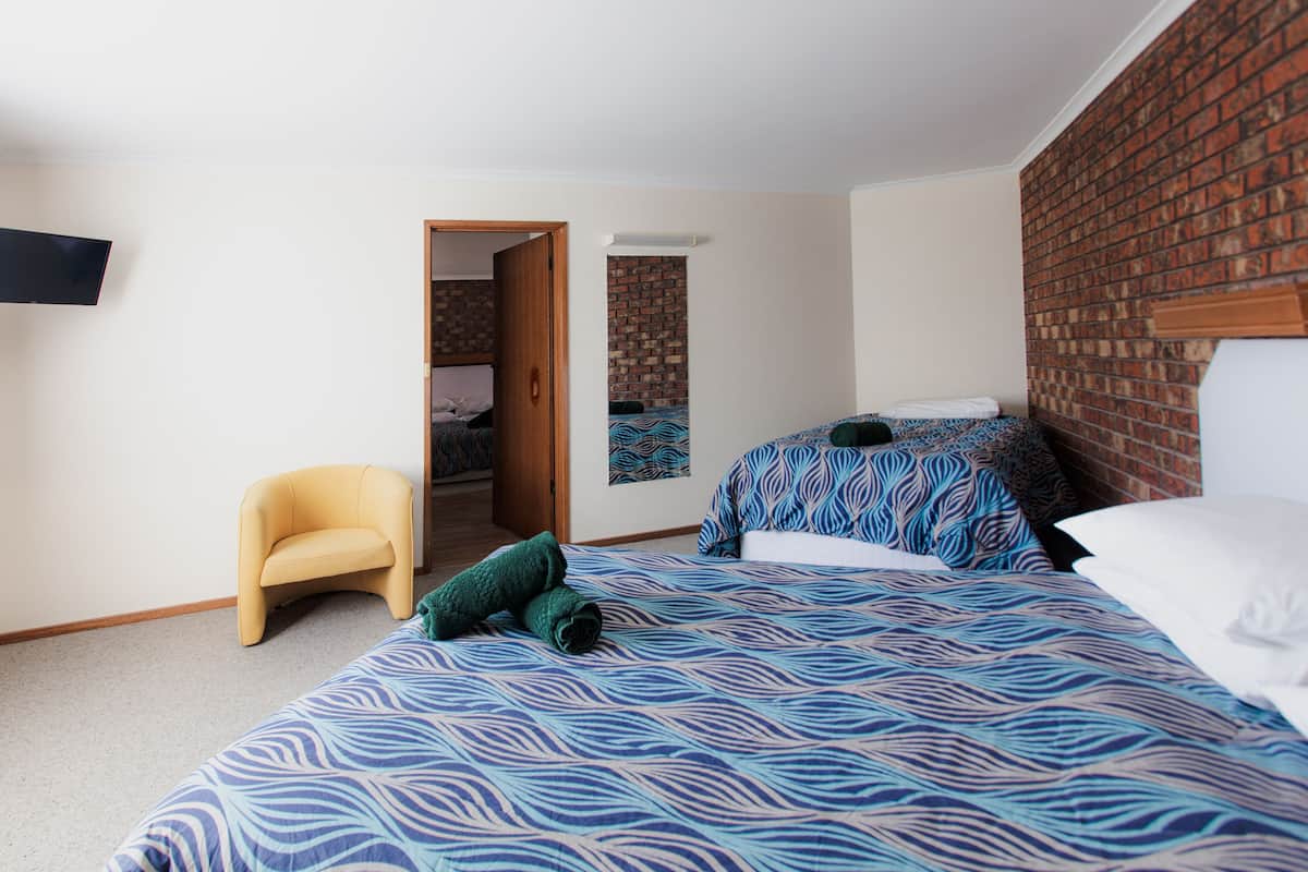 Family Quadruple Room | Minibar, desk, laptop workspace, iron/ironing board