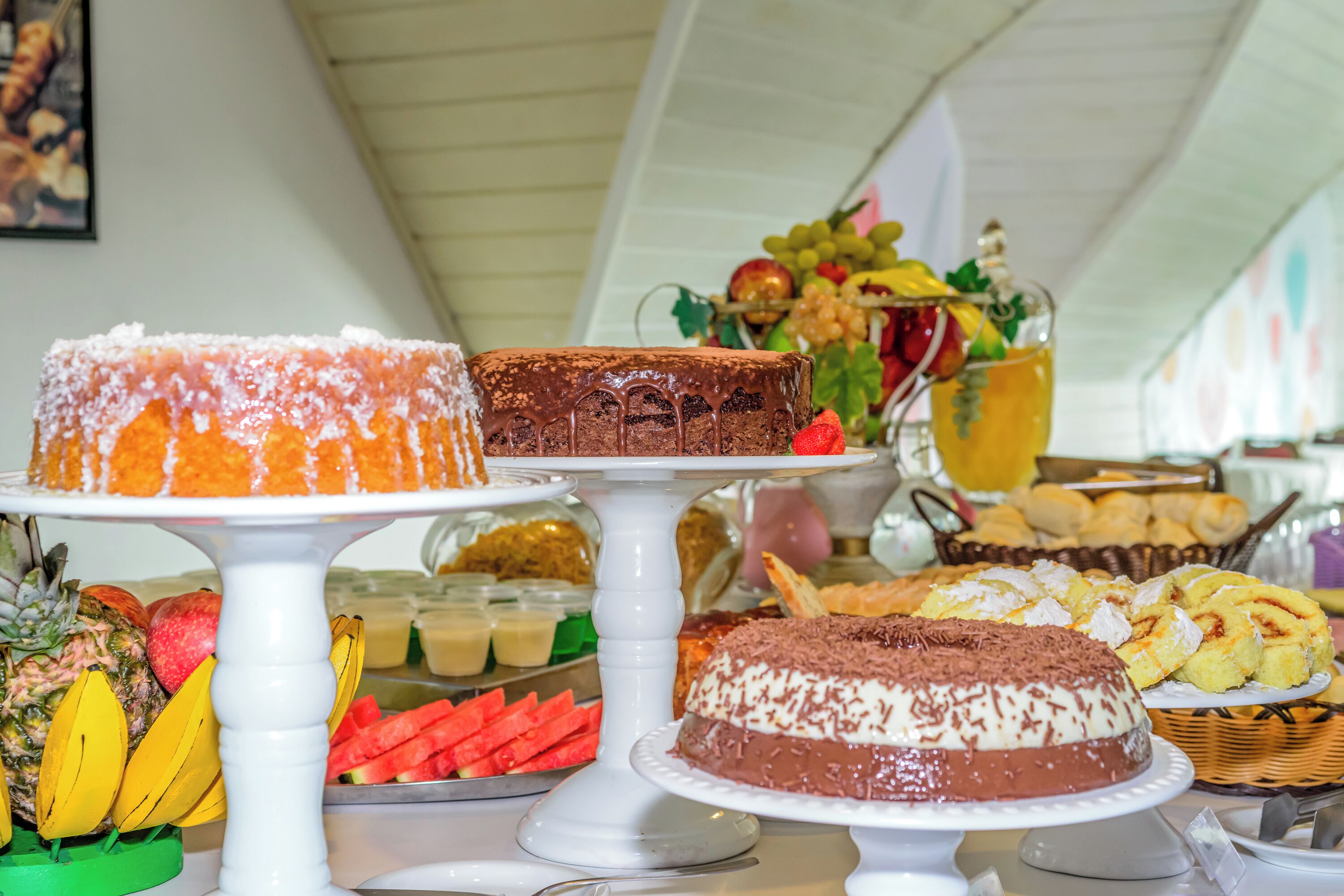 A buffet table with various desserts and fruits.