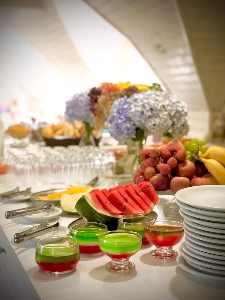 A buffet table with various food items and drinks.