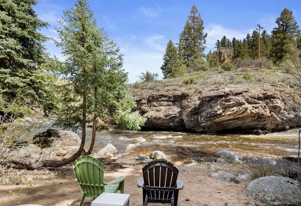 Une rivière aux rives rocheuses, une chaise et une table, le tout dans un cadre naturel.