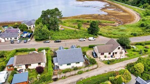 A residential area with houses, a road, and a lake.