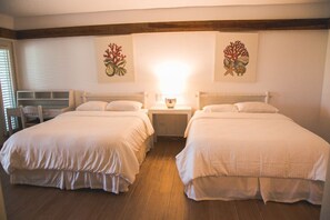 A hotel room with two beds, a nightstand, a lamp, and artwork on the walls. - Cozy Entire Villa with Picuzzi (La Romana)