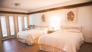 A bedroom with two beds, wooden flooring, and a large window with blinds. - Cozy Entire Villa with Picuzzi (La Romana)