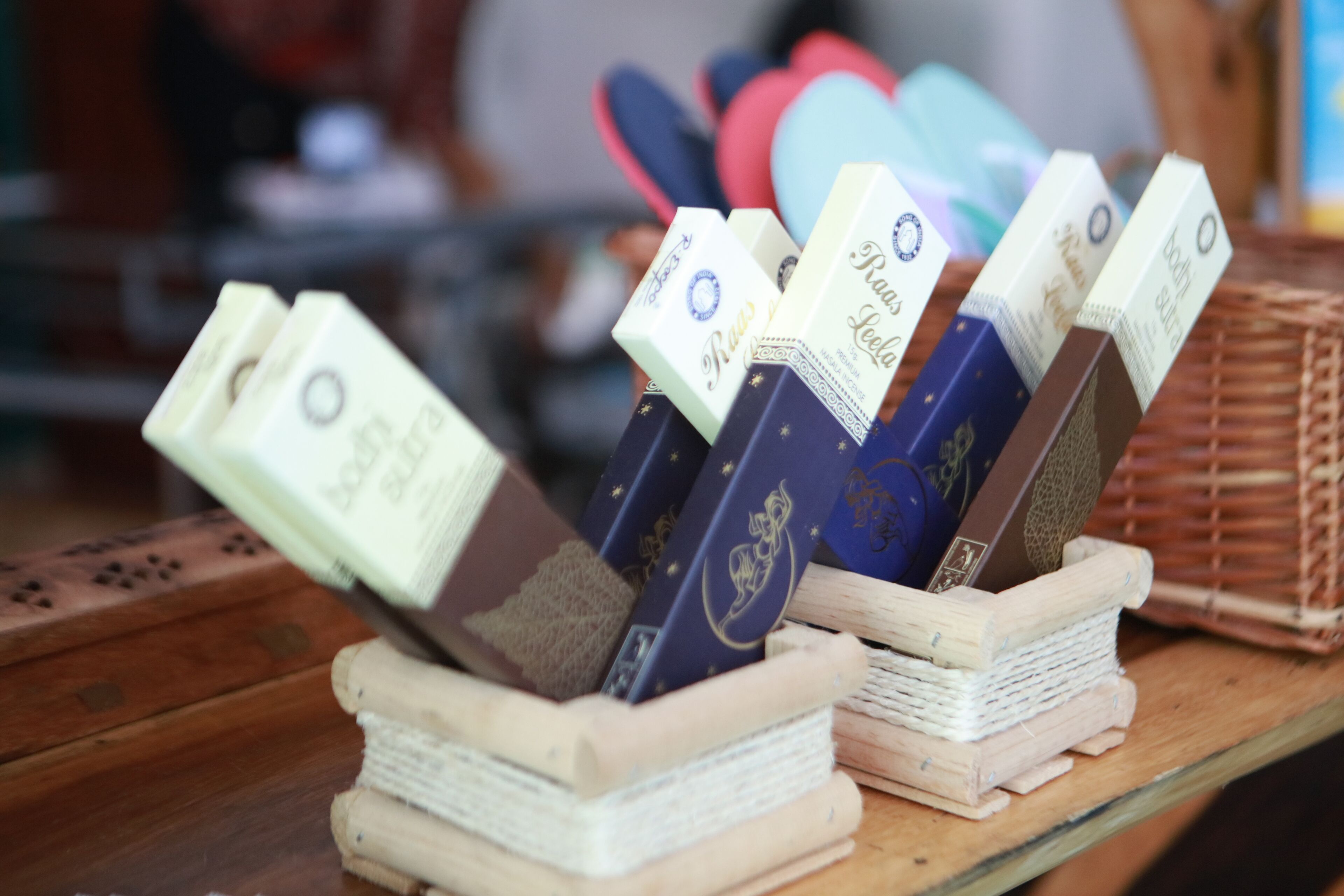 A display of books and boxes on a wooden table.