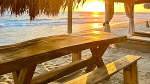 A beachside wooden structure with a thatched roof overlooking the ocean at sunset. - Hotel Boutique Punta Jamaica (Coyuca de Benitez)