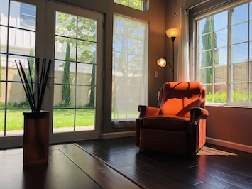 Spacious living room area with all windows around to enjoy natural light.