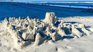 A sandy beach with a large sandcastle structure. - WEEKLY SUMMER SPECIALS! Oceanfront Condo - Heated Pool - NO DRIVE BEACH (Daytona Beach Shores)