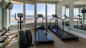 Ein Heimfitnessraum mit Laufbändern, einem Ergometer und Kurzhanteln.