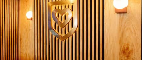 A wooden wall with vertical slats and a decorative emblem.
