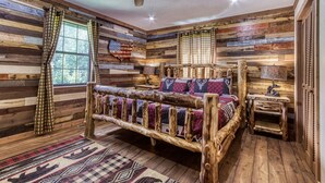 A rustic wooden bedroom with a bed, curtains, and a ceiling fan. - Stoneybrook Valley Ranch 2,  3Bed/2Bath, DOG Friendly, 1.5 Acres Great Mtn views (Sevierville)