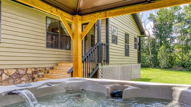 A hot tub area with a stone wall and steps leading to a wooden deck. - Stoneybrook Valley Ranch 2,  3Bed/2Bath, DOG Friendly, 1.5 Acres Great Mtn views (Sevierville)