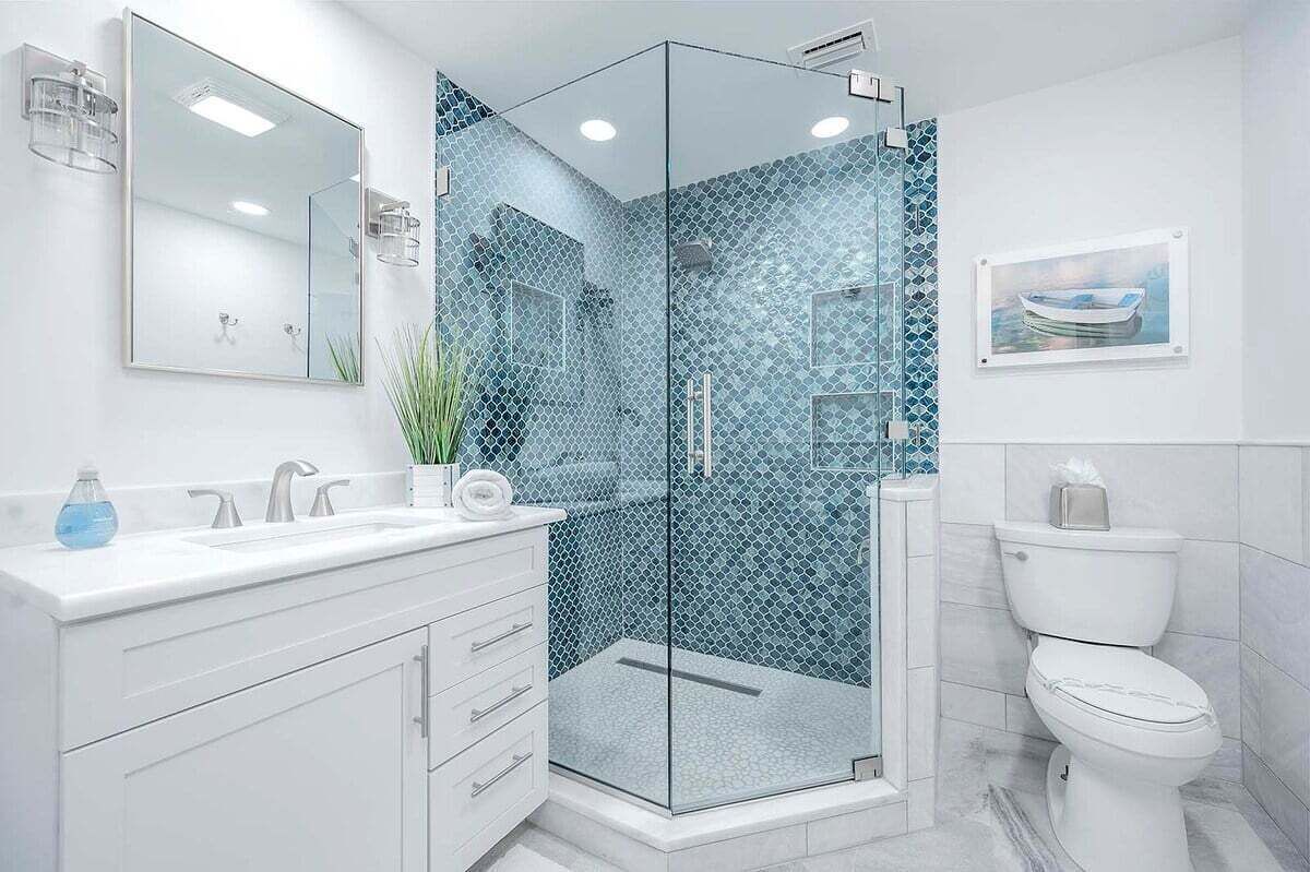 A modern bathroom with a glass-enclosed shower, white vanity, and a toilet.