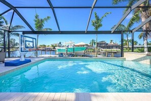 A heated pool, sun loungers