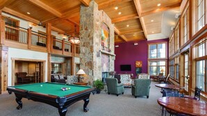 A spacious indoor area with a pool table, comfortable seating, and large windows. - Fantastic New Years Week Ski-In and Ski-Out Grand Timber Lodge Breckenridge, CO (Breckenridge)