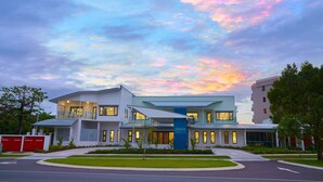 A modern building with a prominent entrance and a sign reading "Spinal Life". - Healthy Living Centre (Cairns North)