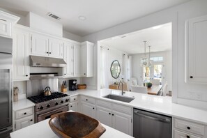 Enjoy cooking in this well-equipped kitchen with a gas stove, oven, and dishwasher, plus ample counter space and a large island.