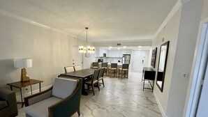 A spacious living room with a dining area, a kitchen in the background, and a marble floor. - Westgate Vacation Villas (Kissimmee)