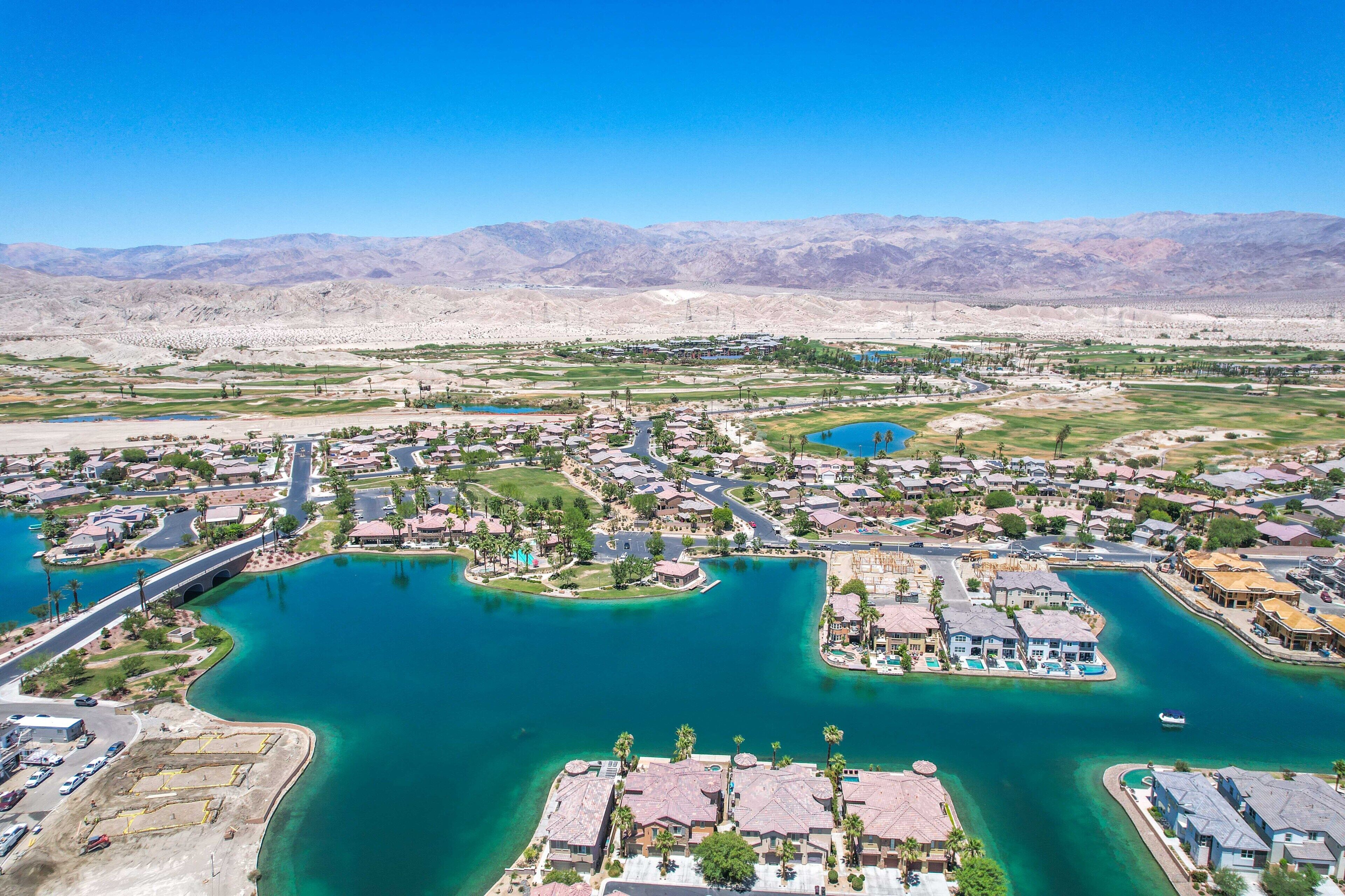 A coastal town with residential areas, a marina, and a bridge.