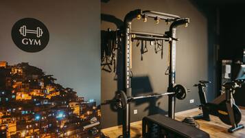 A gym with a squat rack, barbell, and weight plates.