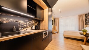 A modern kitchen with a cityscape backsplash, a built-in oven, and a wooden countertop. - Rioca Stuttgart Posto 4 (Stuttgart)
