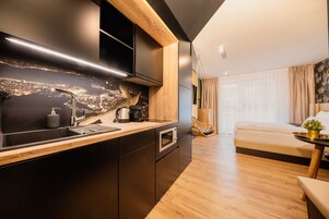 Una cocina moderna con un backsplash que muestra un paisaje urbano, un horno empotrado y una encimera de madera.