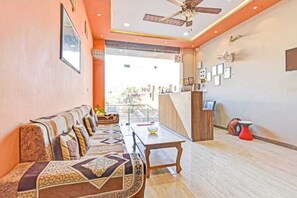Relax in a stylish space with a long sofa, wooden coffee table, and framed artwork.