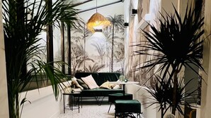A cozy indoor space with a ceiling garden, a sofa, and a small table. - ✨ Luxury 2BR - 300m from Eiffel Tower - Rue Cler area (Paris)