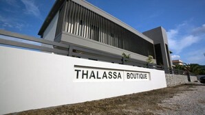 A modern building with a sign reading "THALASSA BOUTIQUE". - THALASSA BOUTIQUE HOTEL (Sithonia)