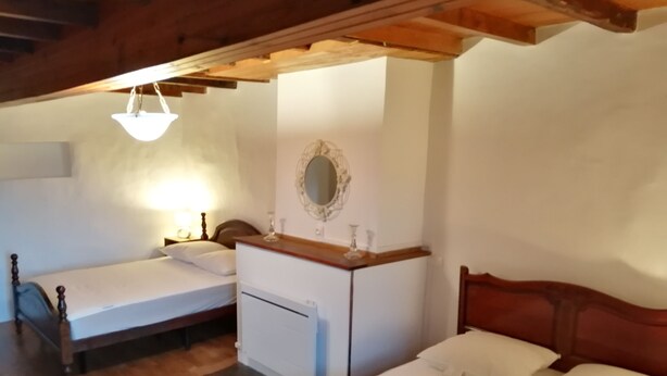 A bedroom with two single beds, a wooden dresser, a mirror, and a ceiling light. - 2 Bedroom Private vacation home in Soueix-Rogalle (Soueix-Rogalle)