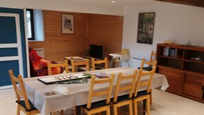 A dining area with a table set for six, surrounded by wooden chairs. - 2 Bedroom Private vacation home in Soueix-Rogalle (Soueix-Rogalle)