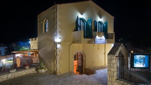 A building with a sign reading "Skanadalis" and a stone pathway leading to it. - Skandalis Apartment with pool view (Theano) (CHORAFAKIA CHANIA)