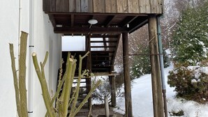 A wooden structure with a balcony, possibly a birdhouse or lookout, attached to a building. - CHALET ROMANE, SLEEPS 6, LAKE VIEW, AIR-CONDITIONED, BALCONY, MOTORCYCLE ROOM, GERARDMER (Gérardmer)