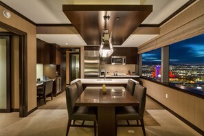 Enjoy meals or entertain in the spacious dining area with a long table and comfortable seating.