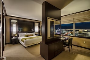 Experience the city from your retreat, featuring a large bed, dark dresser, and city views.