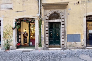 A building with a green door and a shop entrance with festive decorations.