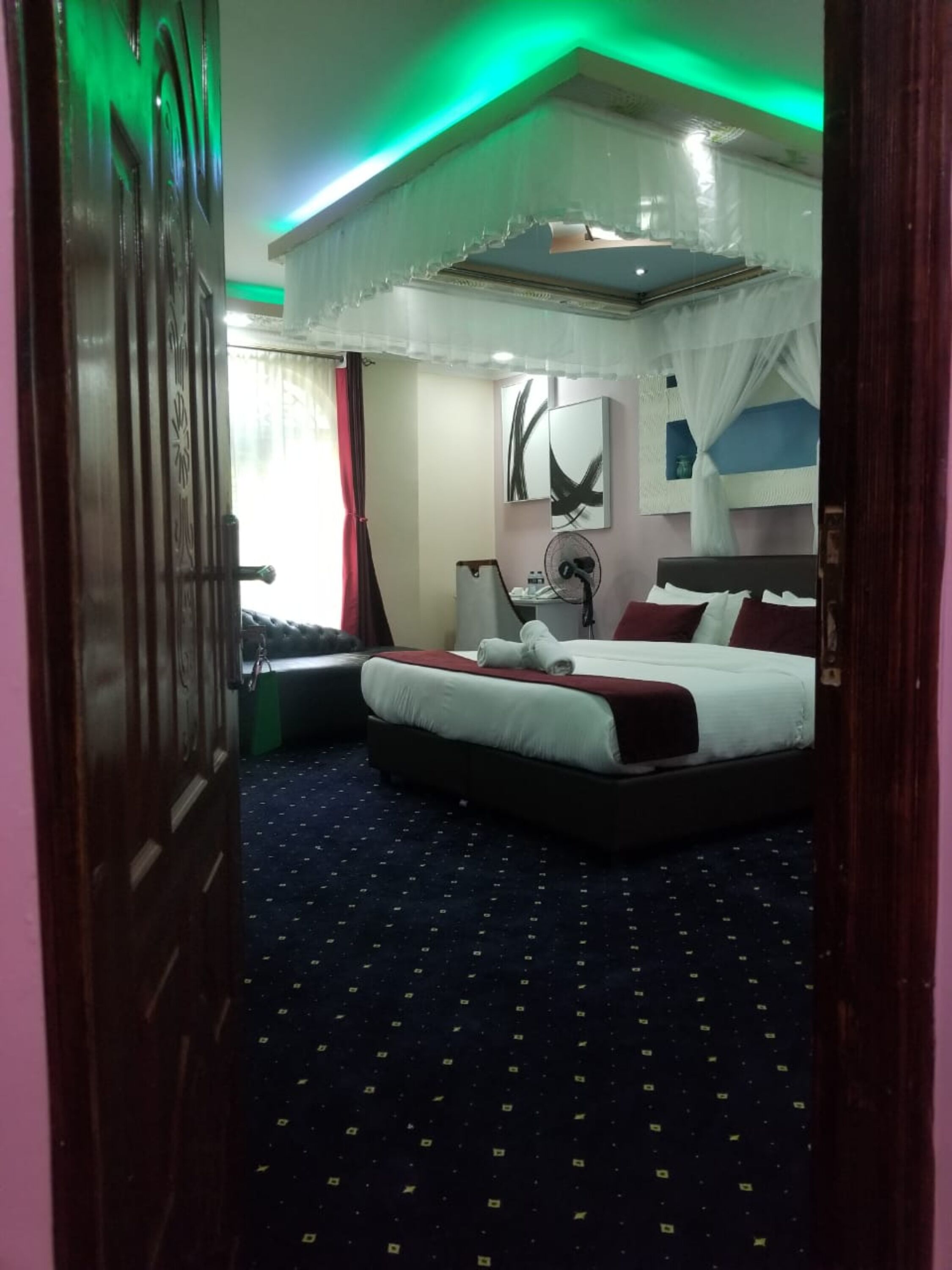 desk, laptop workspace, bed sheets