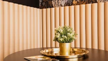 A round table with a gold tray and a potted plant.