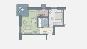 Planta baixa mostrando uma sala de estar, cozinha, espaço de jantar e banheiro.