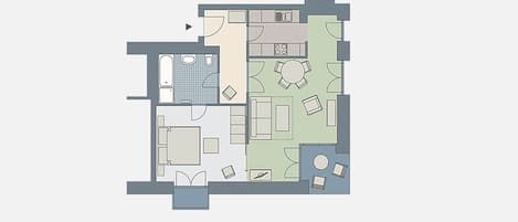 Een plattegrond van een hotelkamer met een badkamer, een eetgedeelte en een woongedeelte.