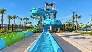 A water park with multiple water slides and a pool.