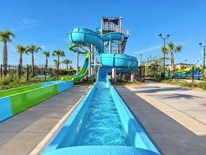 A water park with multiple water slides and a pool.