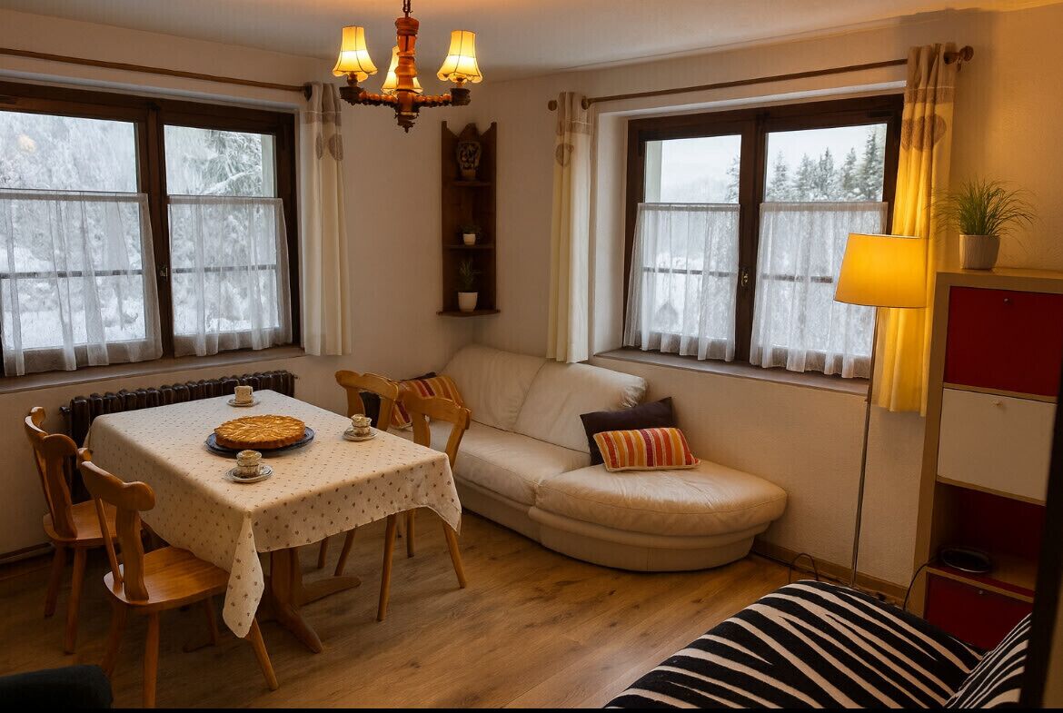 A cozy room with a dining table, chairs, a sofa, and a lamp.