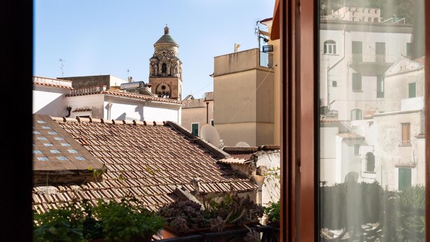 A view of a building with a tiled roof and a bell tower. - Stefania Flat- Amalfi centre (Amalfi)