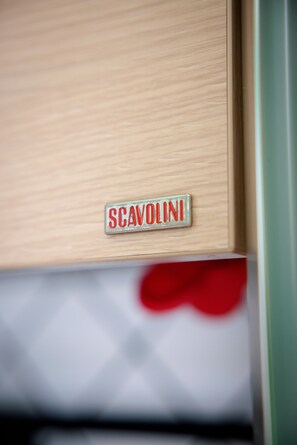 A wooden panel with a metal plaque that reads "SCAVOLINI". - Relaxing, comfortable, and convenient for exploring Naples (Napoli)