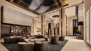 A modern hotel lobby with seating areas, a reception desk, and a bar. - Eurostars Ambassador (Budapest)